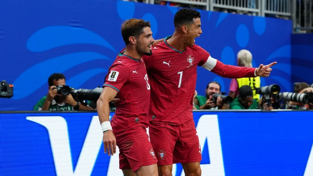 Porgual key player Christiano Ronaldo hold his teammate to celebrate his scores during a 5-0 World Cup win against Uzbekistan
